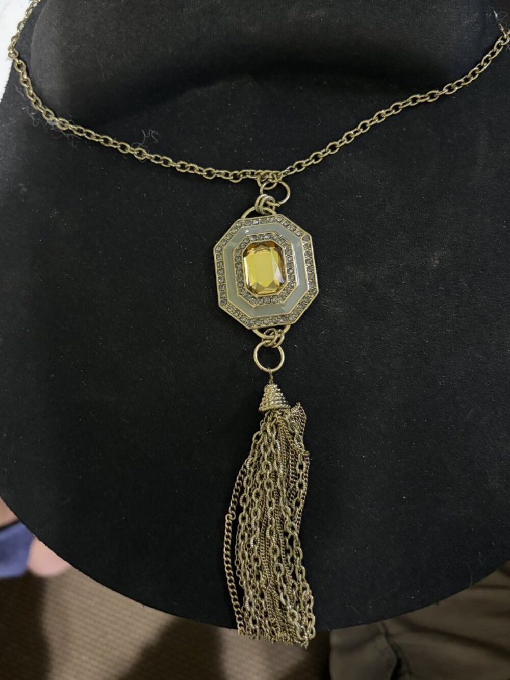22" Gold tone chain and medallion with gold like chain tassels.